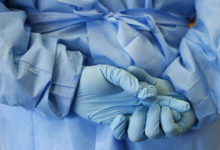 The gloved hands of an army nurse