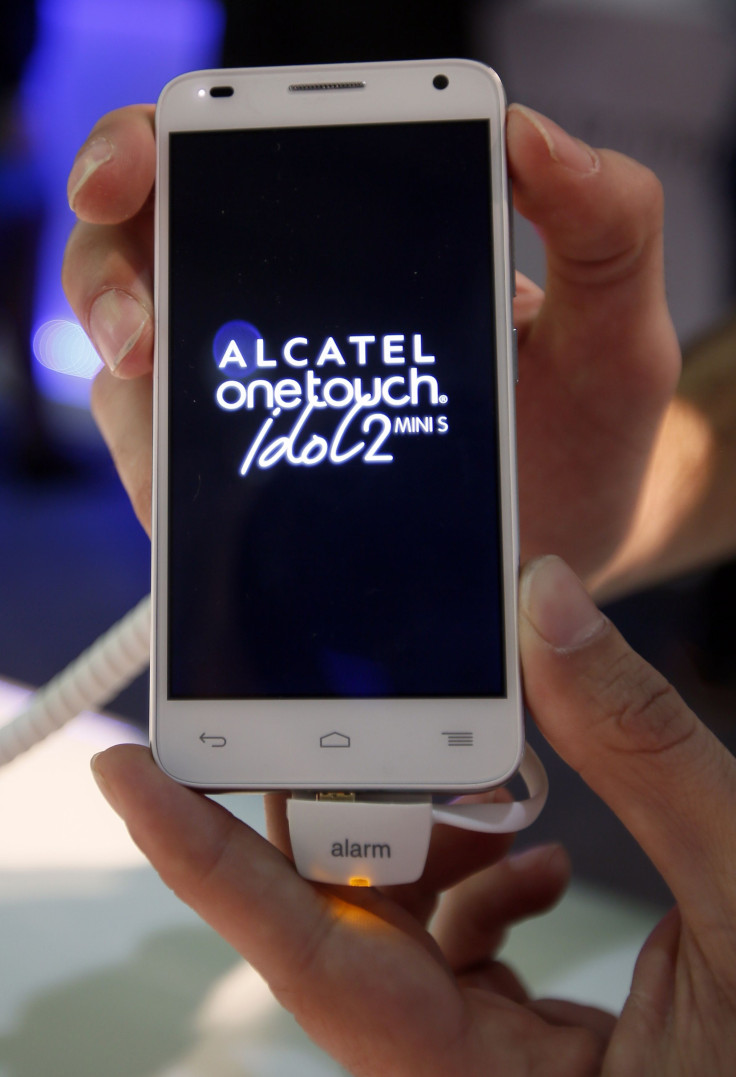 A model displays an Alcatel OneTouch Idol2 Mini S handset at the company's stand at the Mobile World Congress in Barcelona February 24, 2014.