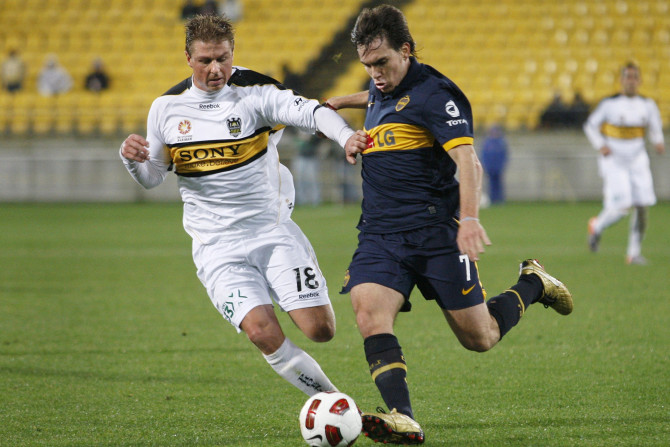 Wellington Phoenix's Sigmund challenges Boca Juniors' Mouche during their friendly soccer match in Wellington