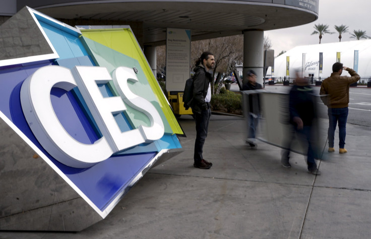Workers pass by a sign outside the Consumer Electronics Show in Las Vegas, January 5, 2016. 