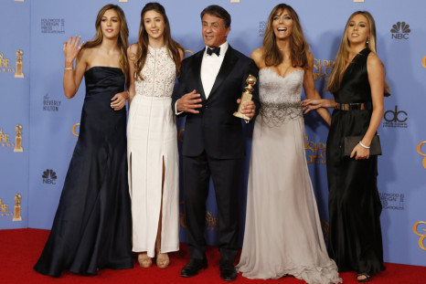 Sylvester Stallone and his wife Jennifer Flavin (2nd R) and their daughters, Sistine (L), Scarlet, (2nd L) and Sophia, pose with his award for Best Performance by an Actor in a Supporting Role in any Motion Picture