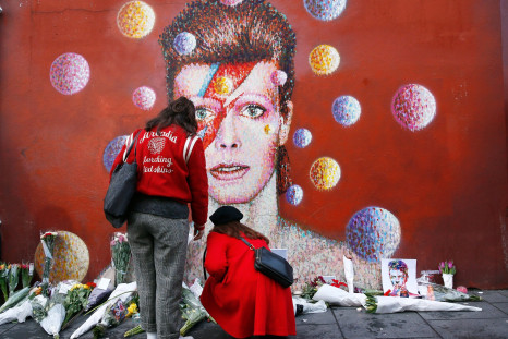 Two women stop at a mural of David Bowie in Brixton