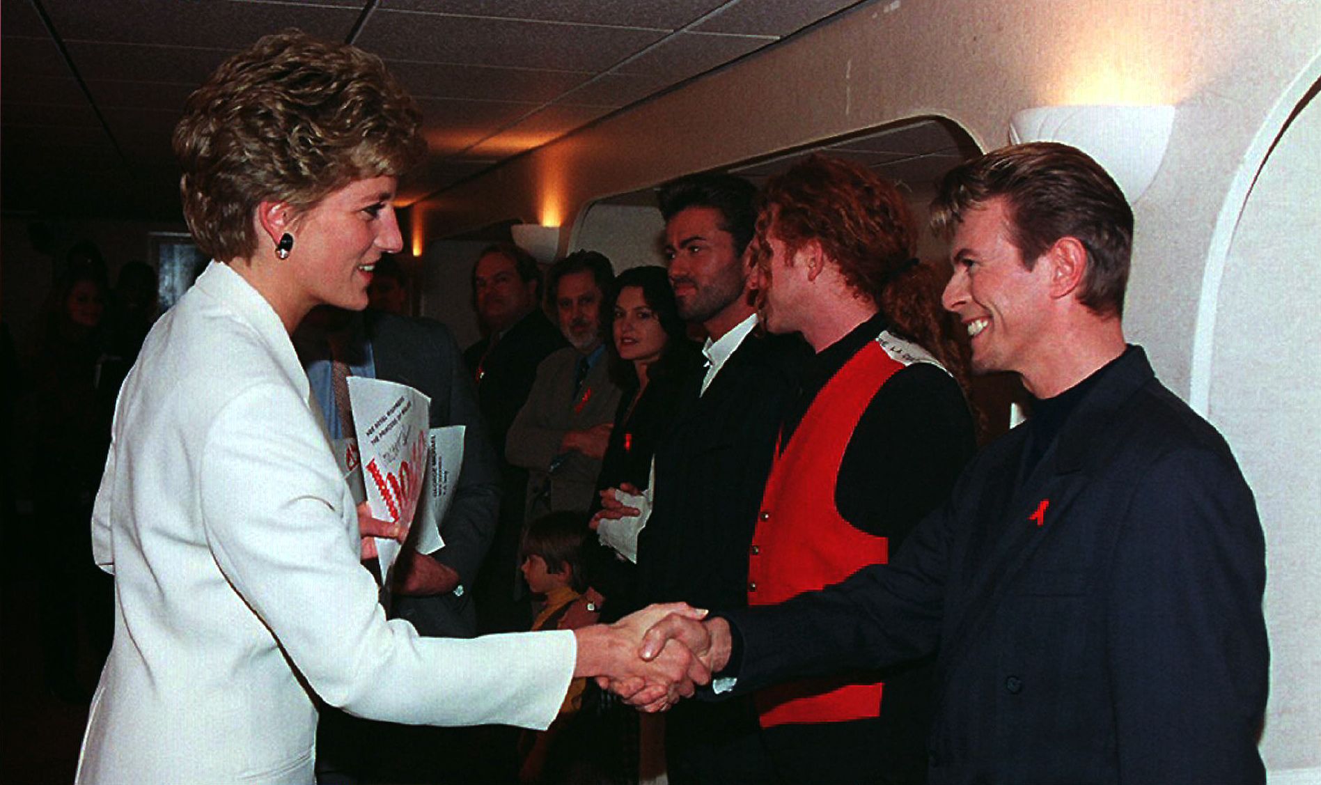 Princes Diana, Patron of the National AIDS Trust, greets singer David Bowie R backstage at Wembley Arena in London