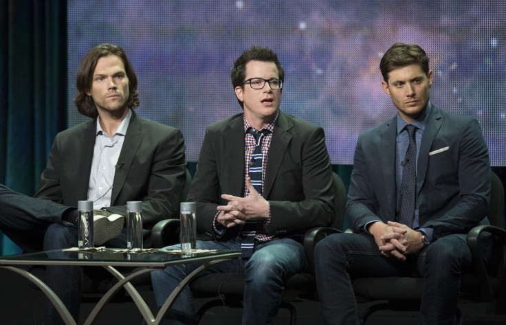 Writer Jeremy Carver (C) speaks next to cast members Jared Padalecki (L) and Jensen Ackles at a panel for The CW television series "Supernatural"