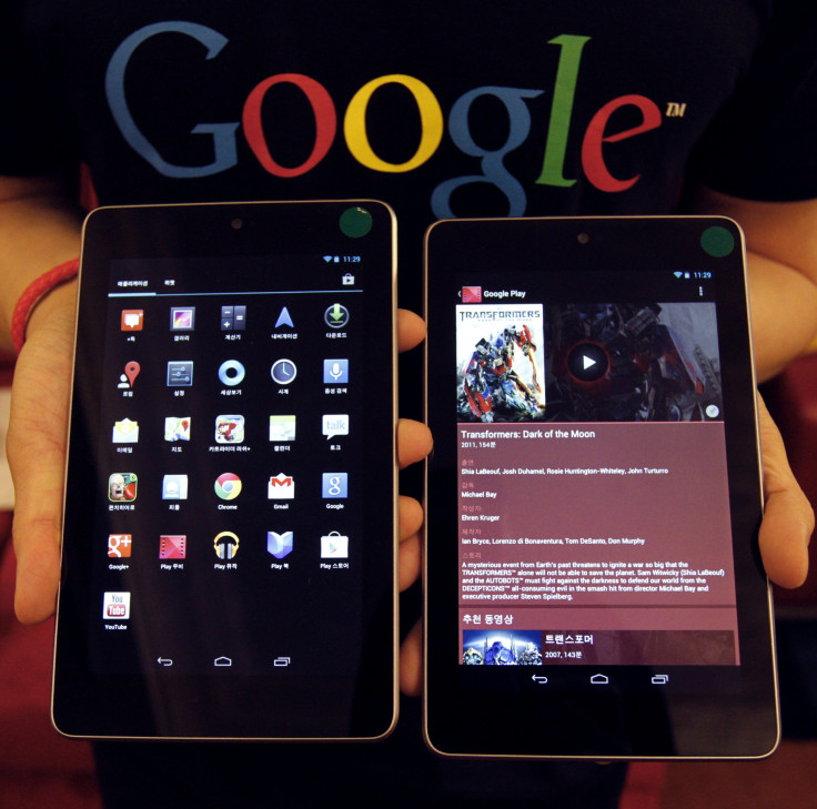 A Google employee poses with Nexus 7 tablets at a promotional event in Seoul September 27, 2012.