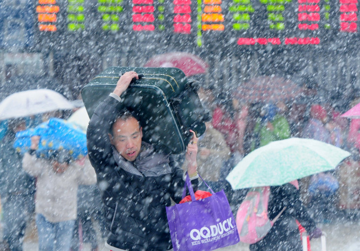 A man carrying luggage in poor weather 