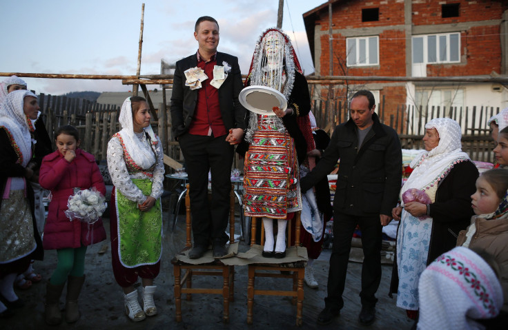 Bulgarian Muslims Azim Liumankov (C left) and his bride Fikrie Bindzheva pose in front of their house during their wedding ceremony in the village of Ribnovo, in the Rhodope Mountains.