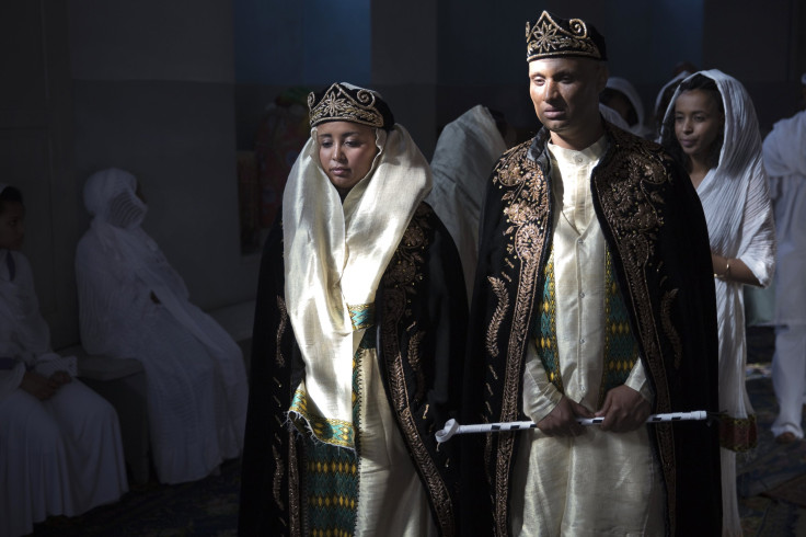 A bride and groom wearing traditional Eritrean dress arrive for their wedding at a Christian Orthodox church in Jerusalem.