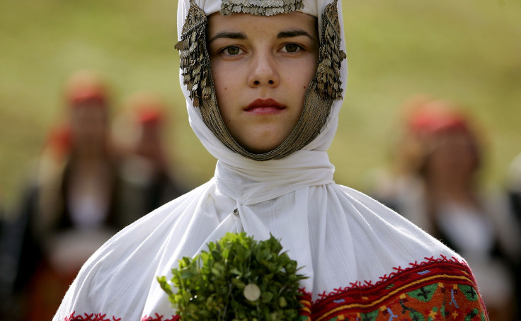 A Bulgarian woman dressed in a traditional wedding dress participates in the Rozhen folklore festival, one of Bulgaria's biggest traditional folklore festivals, in the Rhodope mountains, some 250 km (155 miles) south-east of the Bulgarian capital Sofia
