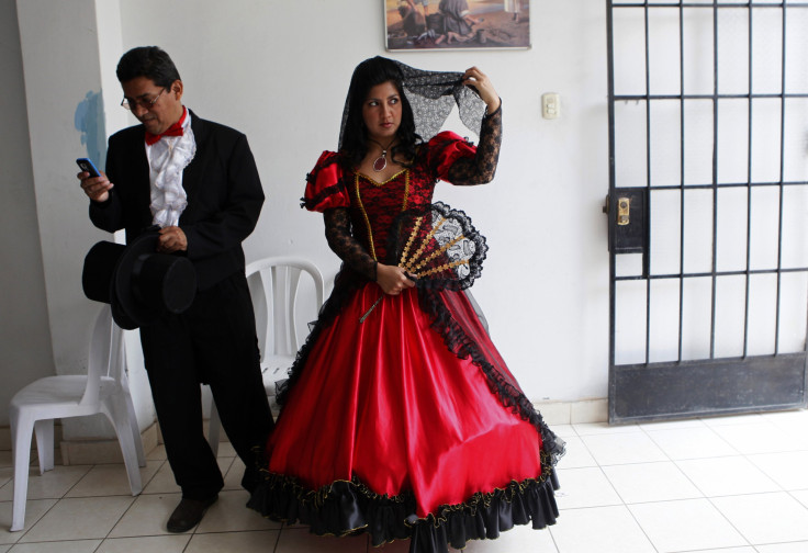 A couple wearing traditional clothes wait for the start of a mass wedding ceremony, in the district of Comas in Lima. 