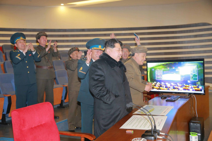 North Korean leader Kim Jong Un reacts as he watches a long range rocket launch