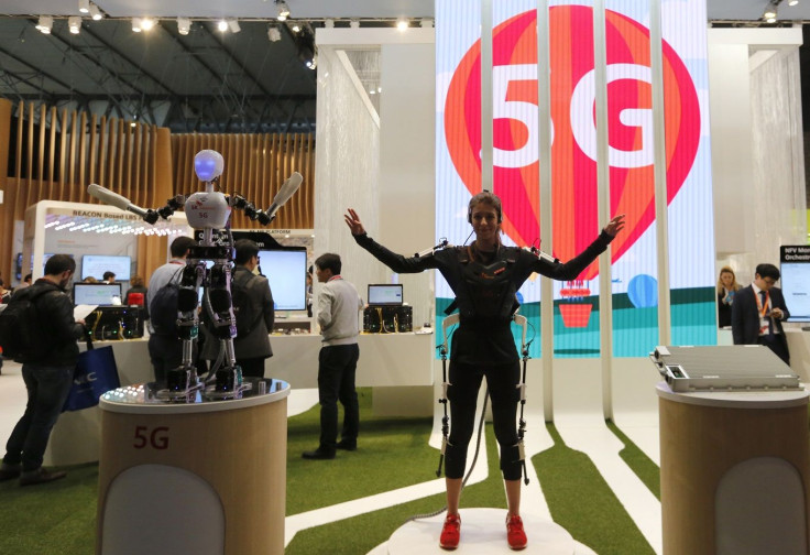 An SK telecom exhibitor directs the robot's movements using 5G on the last day at the Mobile World Congress in Barcelona March 5, 2015.