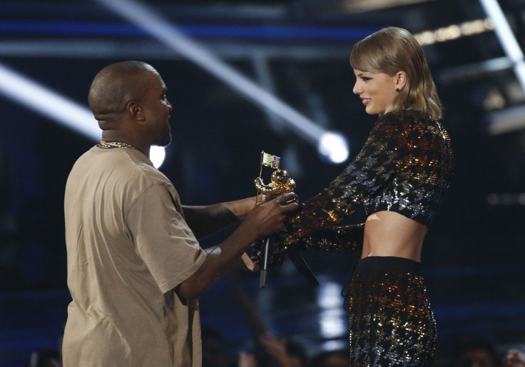 Taylor Swift presents the Video Vanguard Award to Kanye West at the 2015 MTV Video Music Awards in Los Angeles, California, August 30, 2015.