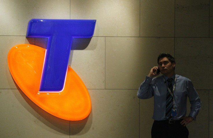 A man uses his mobile phone in front of a Telstra Logo in central Sydney August 13, 2009.