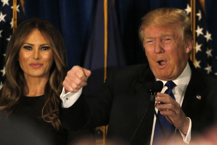 Republican U.S. presidential candidate Donald Trump reacts on stage as his wife Melania looks on at his 2016 New Hampshire presidential primary night rally in Manchester, New Hampshire February 9, 2016.