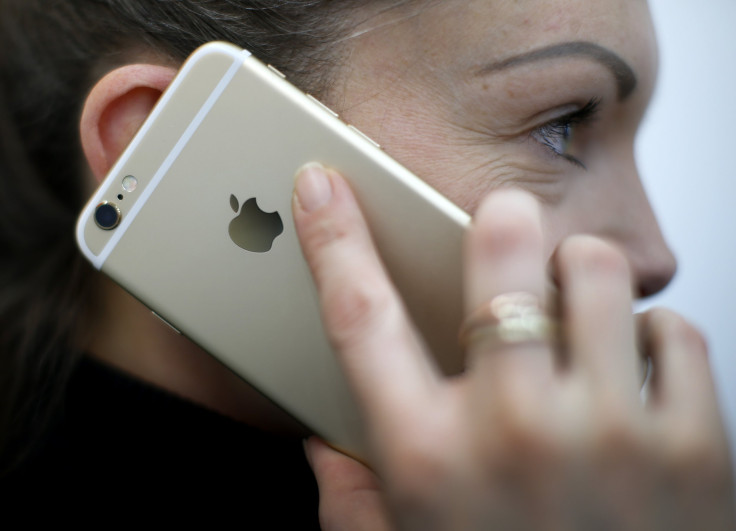 A woman uses her mobile phone, an iPhone 6 by Apple in Munich downtown, Germany, January 27, 2016. 