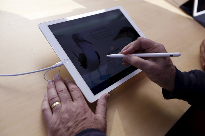 A man uses an Apple Pencil on an Apple iPad Pro at the Apple Store in Palo Alto, California November 13, 2015. 