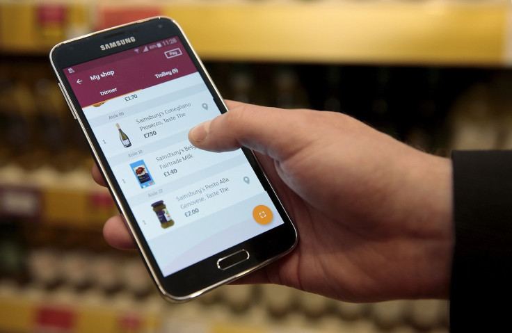A journalist trials a SmartShop mobile app, which is still in development, at a Sainsbury's store in northwest London, Britain October 23, 2015