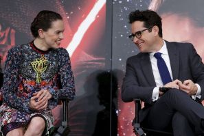 Director J.J. Abrams (R) and cast member Daisy Ridley have a chat during a news conference for their upcoming movie "Star Wars: The Force Awakens" in Urayasu, Chiba prefecture, the suburbs of Tokyo, Japan, December 11, 2015.