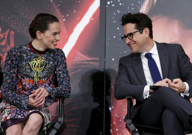 Director J.J. Abrams (R) and cast member Daisy Ridley have a chat during a news conference for their upcoming movie "Star Wars: The Force Awakens" in Urayasu, Chiba prefecture, the suburbs of Tokyo, Japan, December 11, 2015.