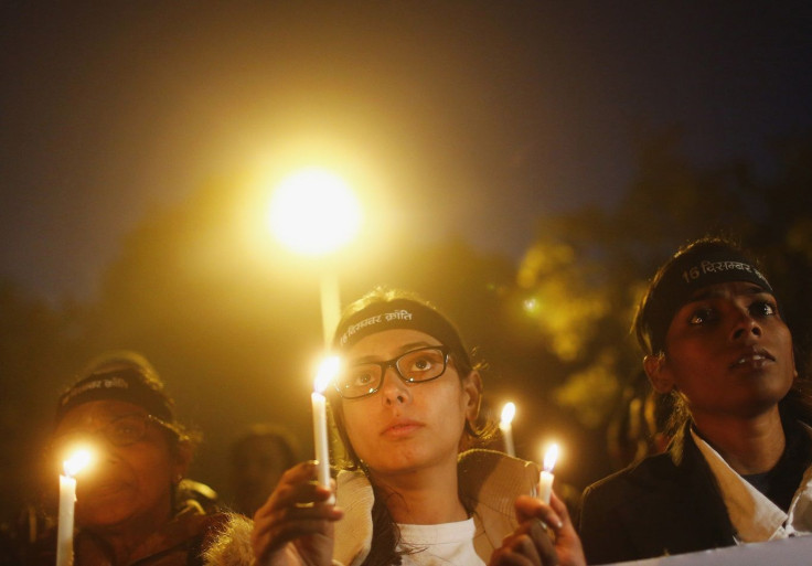 Demonstrators hold candles during a candlelight vigil to mark the first death anniversary of the Delhi gang rape victim, in New Delhi December 29, 2013.