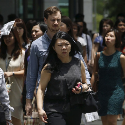 Office workers leave for lunch at the central business district in Singapore March 23, 2016.