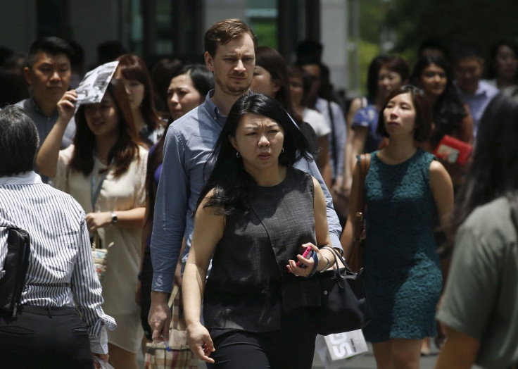 Office workers leave for lunch at the central business district in Singapore March 23, 2016.