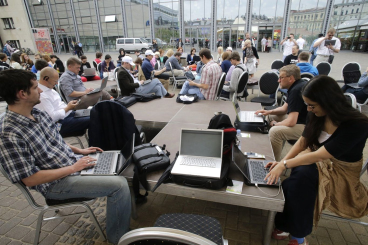 People use their laptops during "Working everywhere" event in Riga May 31, 2013.