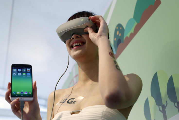 A model poses for photographs with the new model visual device LG 360 VR and the G5 smartphone during its launch event in Taipei, Taiwan March 24, 2016.