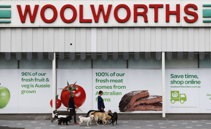 Women walk dogs in front of a Woolworths store in Sydney July 30, 2013.
