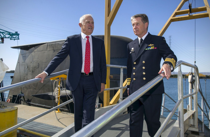 Australian Prime Minister Malcolm Turnbull (L) disembarks an Australian Navy submarine with Australian Navy officer Vice Admiral Timothy Barrett