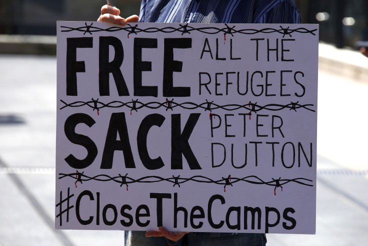 A protester holds a placard during a rally in support of refugees in central Sydney, Australia, October 19, 2015.