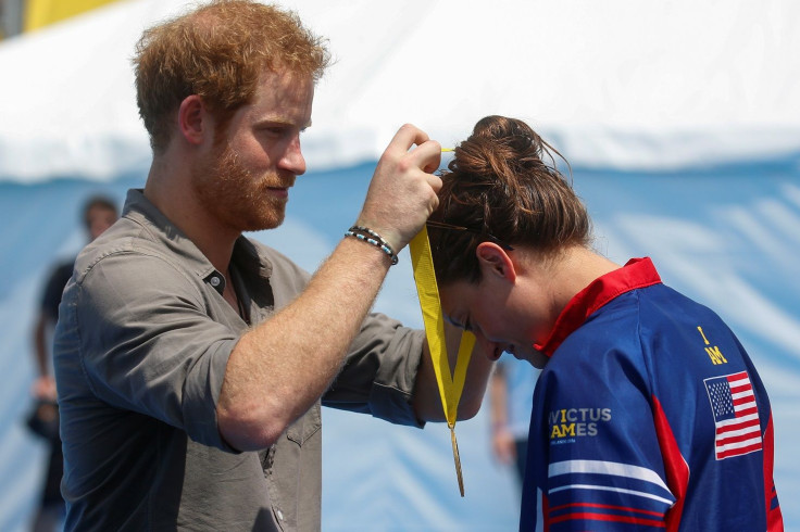 Britain's Prince Harry presents Elizabeth Marks of the U.S. a gold medal during a medal ceremony at the Invictus Games in Orlando, Florida, U.S., May 11, 2016