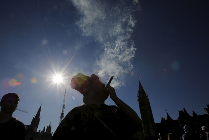 A man smokes marijuana during an annual 4/20 rally on Parliament Hill in Ottawa, Canada, April 20, 2016.
