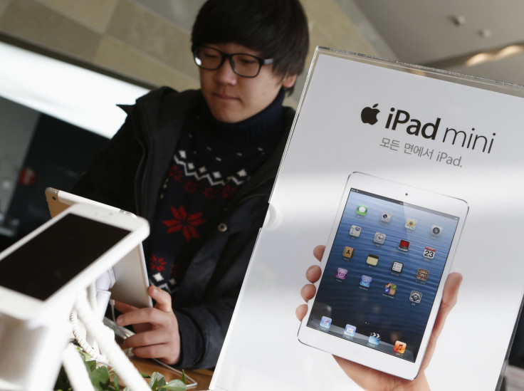 A student tries Apple Inc's iPad mini at an electronics store in central Seoul January 18, 2013. 