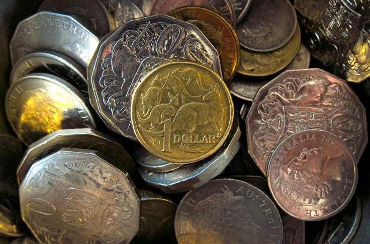 An Australian one dollar coin can be seen amongst various other Australian coins at a store in Sydney, Australia, February 11, 2016.