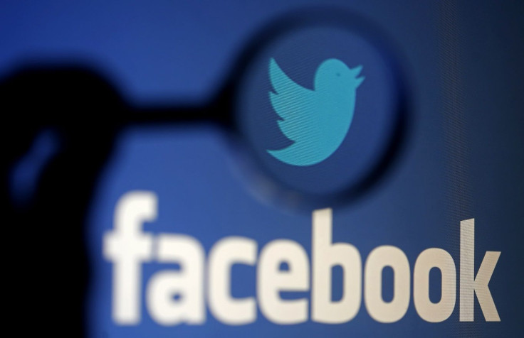 A logo of Twitter is pictured next to the logo of Facebook in this September 23, 2014 illustration photo in Sarajevo.