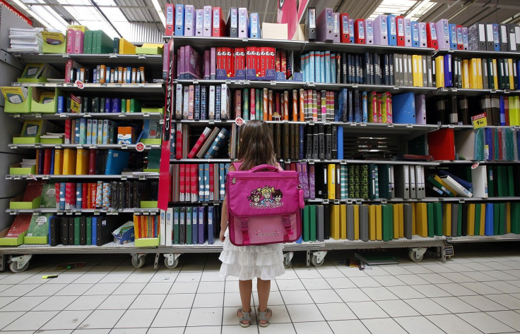 A young girl looks at school stationery in a supermarket in Nice August 23, 2012.