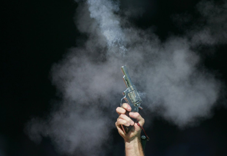 A starter's gun is seen smoking after the start of a men's 200m heat at the Commonwealth Games in Melbourne March 22, 2006.