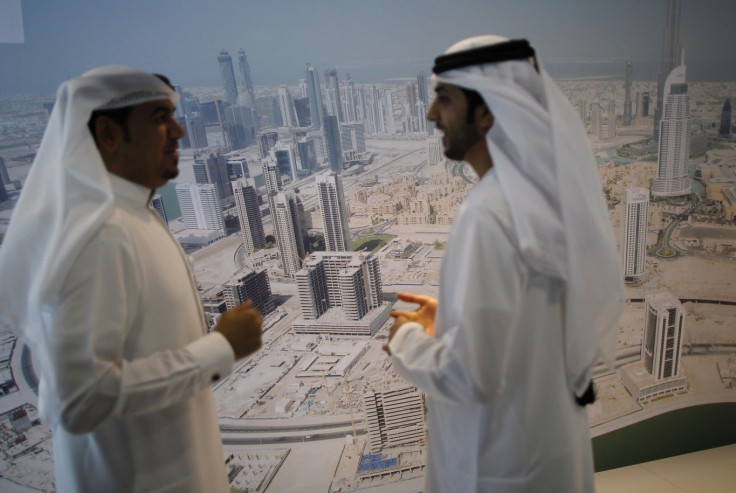 Businessmen chat during the Cityscape real estate exhibition in Dubai October 2, 2012.