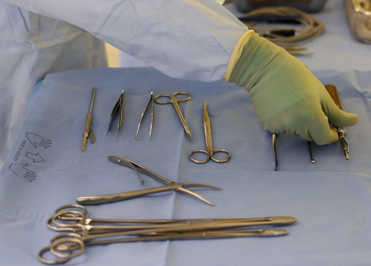 A theatre nurse prepares surgical instruments for an operation on the collar bone of a patient at a hospital in Bern March 28, 2013. Picture taken March 28, 2013.