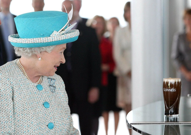 Britain's Queen Elizabeth looks at a pint of Guinness poured by Master Brewer Fergal Murray at the Guinness Storehouse, in Dublin May 18, 2011.