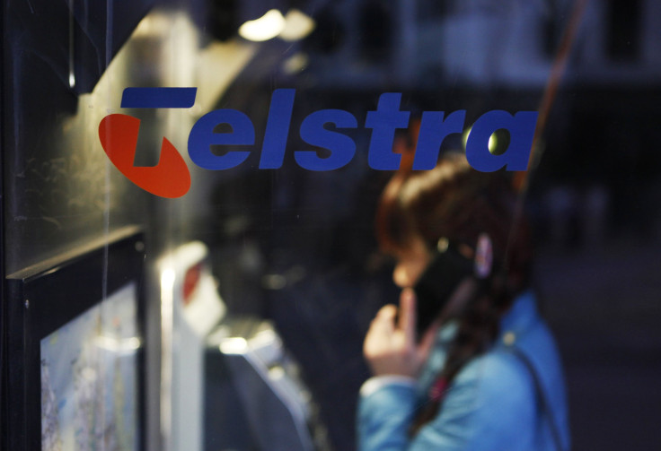 A woman uses a Telstra public phone in suburban Sydney, August 9, 2012.