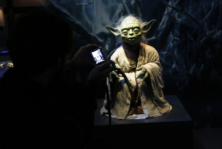 A visitor takes a picture of character Yoda from the Star Wars film series during a press preview for the exhibit "Star Wars Identities" at the MAK museum in Vienna, Austria, December 17, 2015.