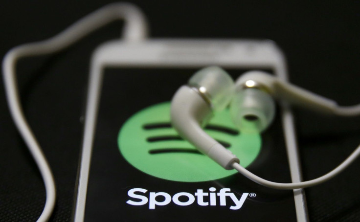 Earphones are seen on top of a smart phone with a Spotify logo on it, in Zenica February 20, 2014.