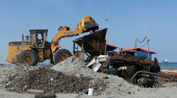 A loader dumps sand into a magnetized black sand mining equipment along the shore line of San Vicente, Ilocos Sur in northern Philippines May 6, 2013.