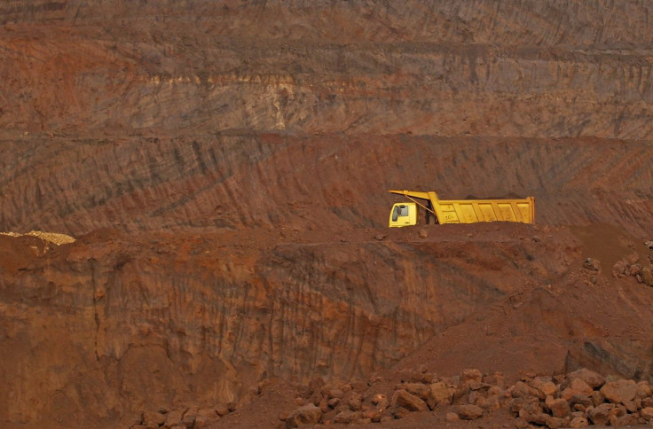A truck passes through an open pit of the Bedara Bhommanahalli (BBH) iron ore mines at Chitradurga in the southern Indian state of Karnataka November 9, 2012.