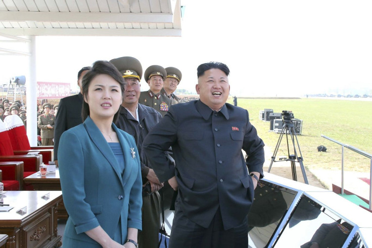 North Korean leader Kim Jong Un (R) stands next to his wife Ri Sol Ju