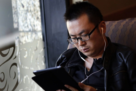 A man use his iPad inside a local coffee shop in downtown Shanghai November 28, 2013.