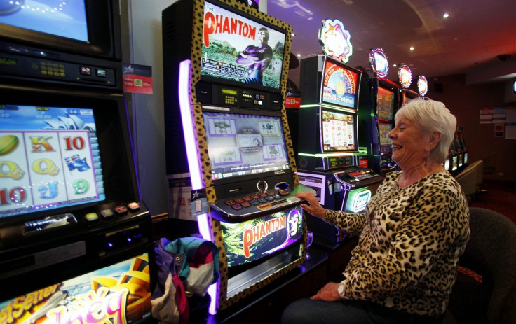 Anna Robinson smiles as she plays with "The Phantom" slot machine at Bowlers Club in Central Sydney November 23, 2011.